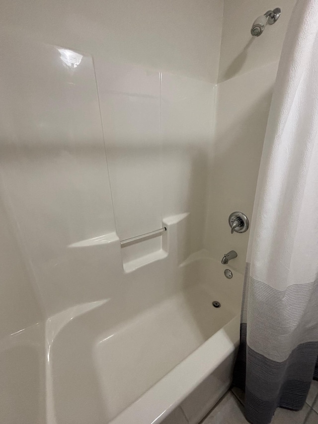 bathroom with tile patterned floors and shower / tub combo