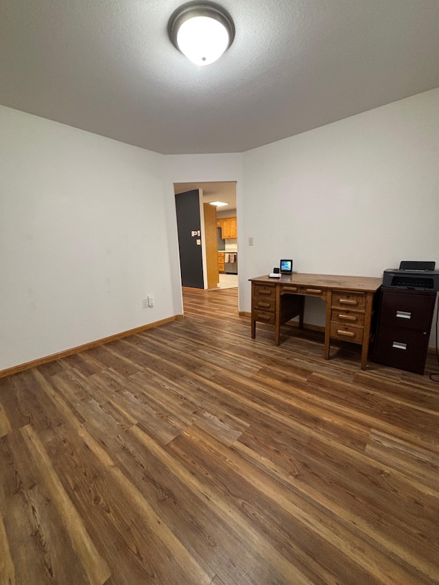 office area featuring dark hardwood / wood-style flooring and a textured ceiling