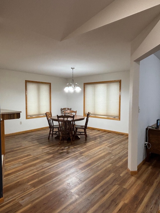 dining area with plenty of natural light, dark hardwood / wood-style flooring, a chandelier, and lofted ceiling