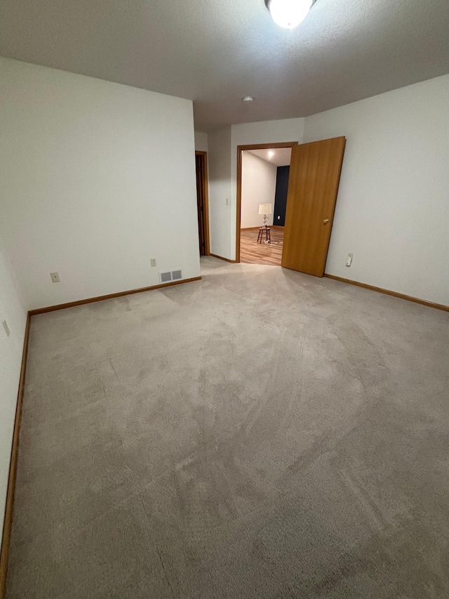 unfurnished room with light carpet