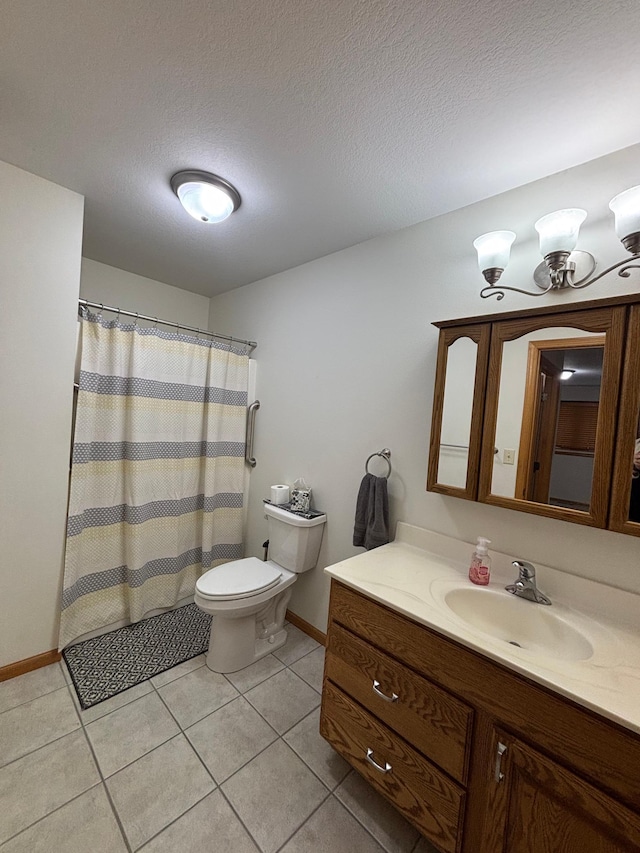 bathroom with tile patterned floors, vanity, a textured ceiling, and toilet