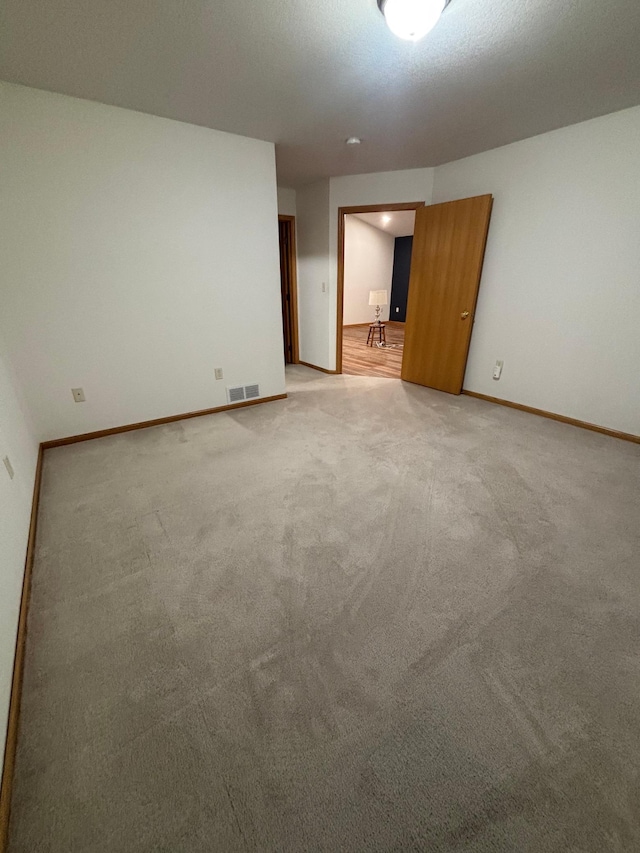 10 Townhouse Rd, Morris, MN 56267 - unfurnished room featuring baseboards and light colored carpet