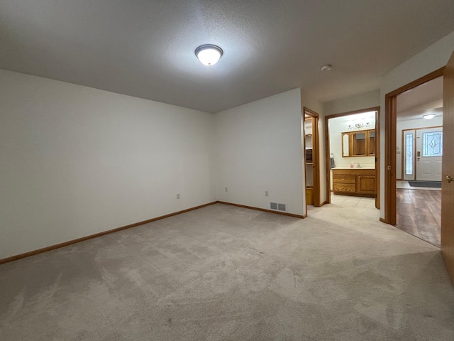 10 Townhouse Rd, Morris, MN 56267 - unfurnished bedroom with light carpet, baseboards, and ensuite bath
