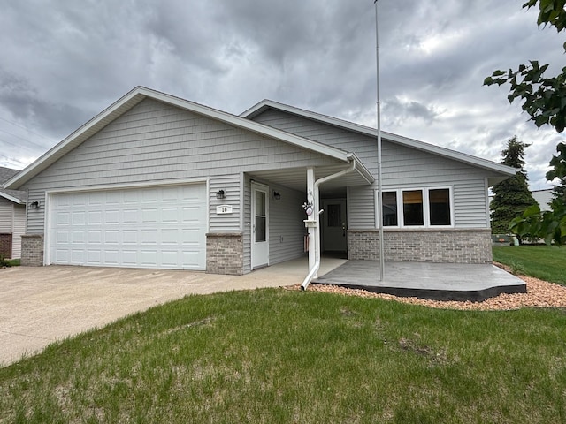 10 Townhouse Rd, Morris, MN 56267 - view of front facade with concrete driveway, a garage, a front lawn, and brick siding