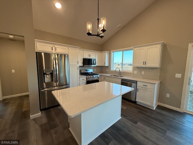 kitchen featuring appliances with stainless steel finishes, a center island, high vaulted ceiling, and white cabinetry