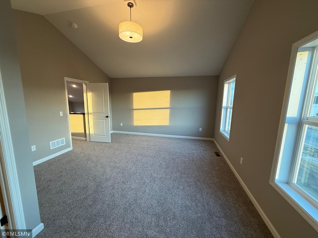 unfurnished bedroom with carpet flooring and vaulted ceiling