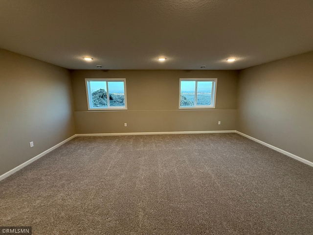 carpeted spare room featuring a wealth of natural light