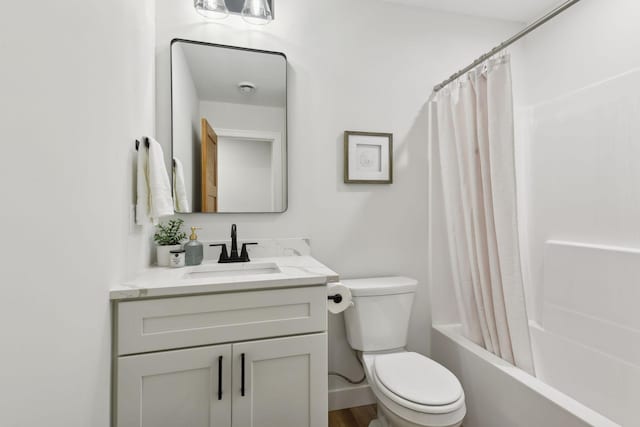 full bathroom with toilet, vanity, shower / tub combo with curtain, and hardwood / wood-style flooring