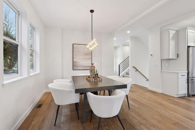 dining room with light wood-type flooring and a wealth of natural light