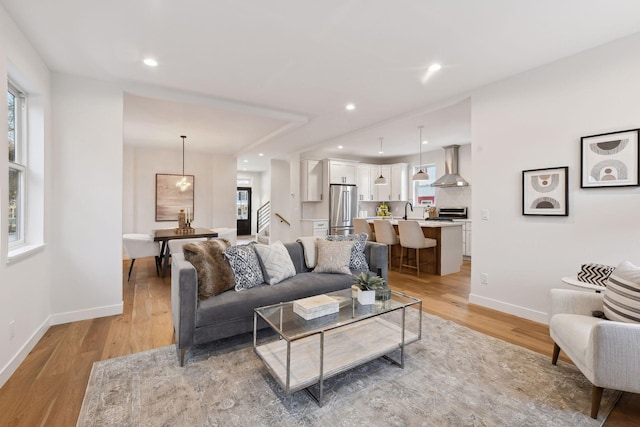 living room featuring light hardwood / wood-style floors and sink