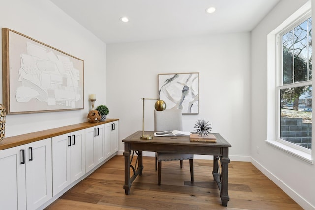 office area with light hardwood / wood-style floors