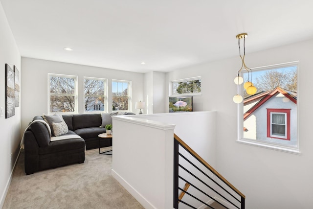 living room with light carpet and a healthy amount of sunlight