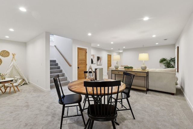 dining space featuring light colored carpet