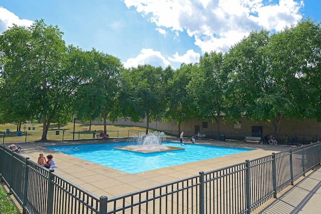 view of swimming pool featuring pool water feature and a patio