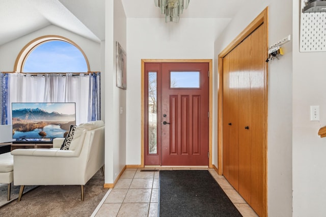 tiled entryway featuring vaulted ceiling