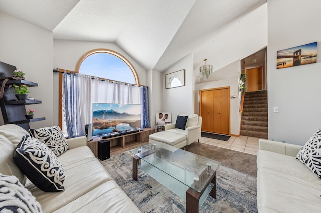 living room with vaulted ceiling, light tile patterned flooring, and a textured ceiling