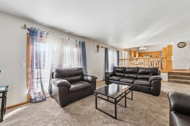 living room featuring light carpet and a textured ceiling