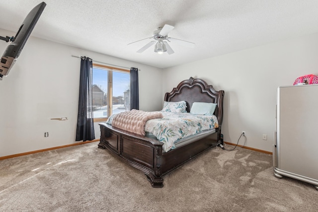 carpeted bedroom featuring ceiling fan and a textured ceiling