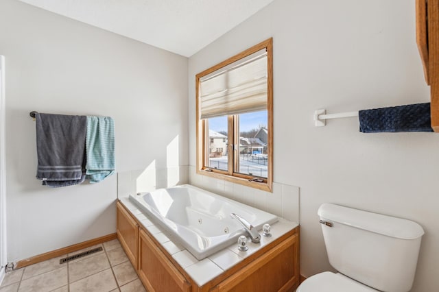 bathroom with tile patterned floors, toilet, and a bathing tub