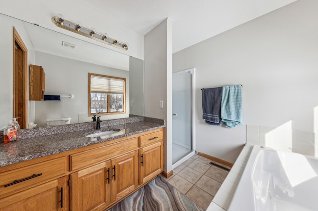 full bathroom featuring vanity, toilet, tile patterned flooring, and shower with separate bathtub