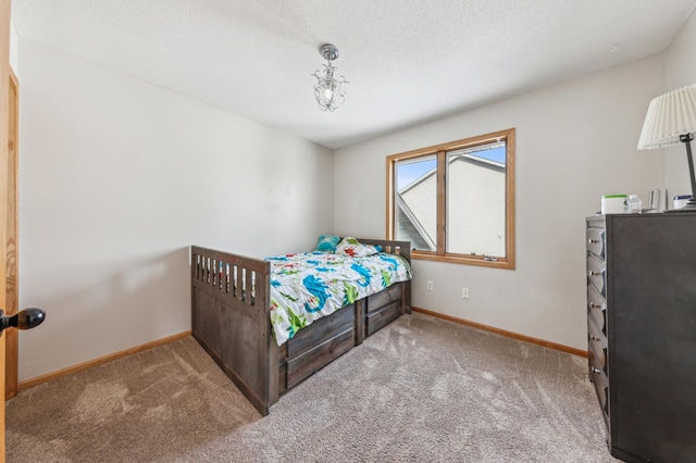 carpeted bedroom with a textured ceiling