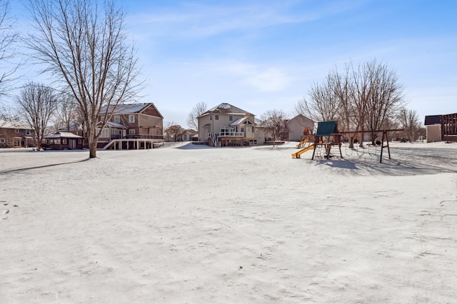 yard layered in snow with a playground