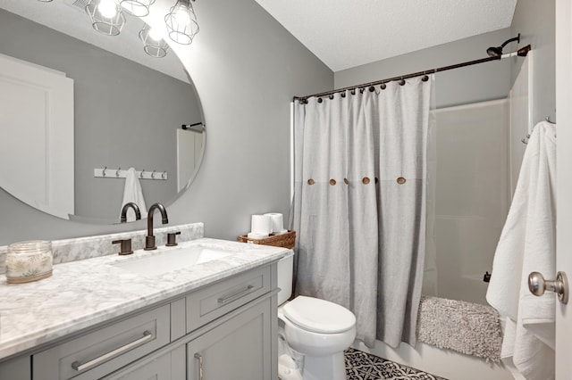 full bathroom featuring vanity, toilet, a textured ceiling, and shower / tub combo