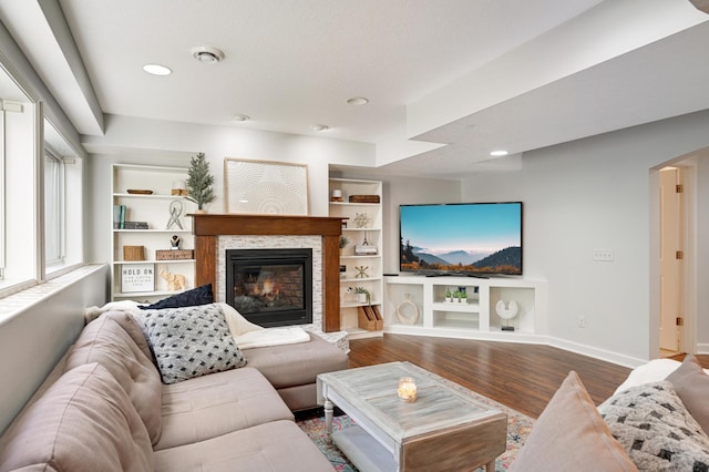 living room with hardwood / wood-style flooring and built in features