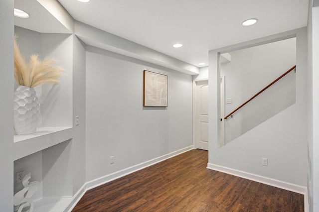 basement with dark hardwood / wood-style floors