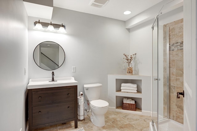 bathroom with vanity, toilet, and an enclosed shower