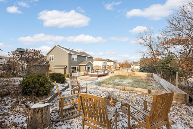 snow covered patio featuring a deck