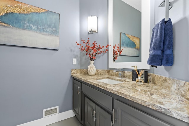 bathroom with visible vents, vanity, and baseboards