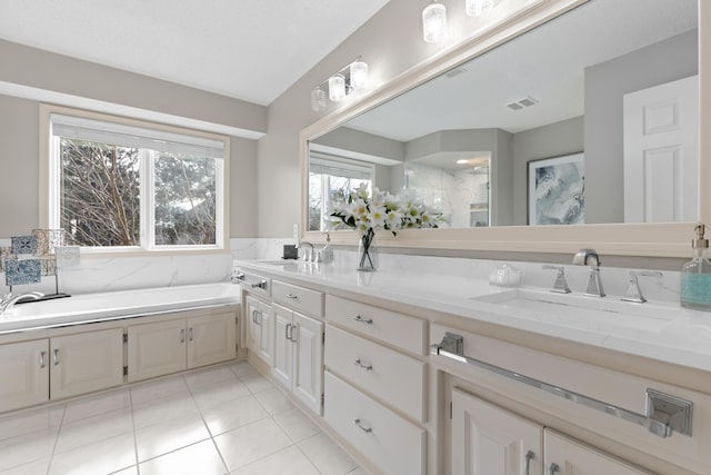 full bath featuring visible vents, a sink, a garden tub, and tile patterned floors