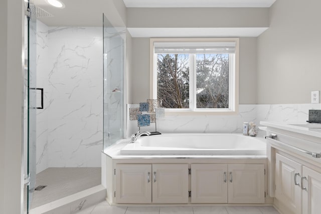 full bathroom with a garden tub, vanity, and a marble finish shower