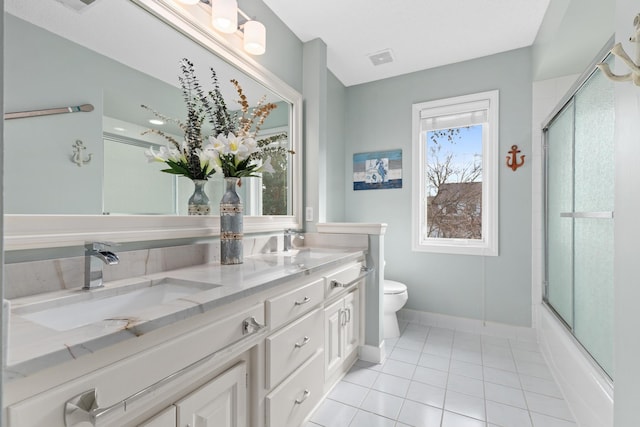 bathroom with visible vents, bath / shower combo with glass door, toilet, tile patterned floors, and a sink