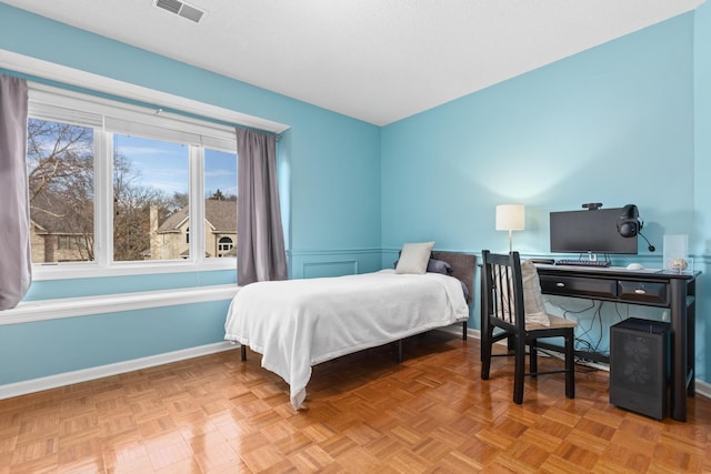 bedroom featuring baseboards, visible vents, and a textured ceiling