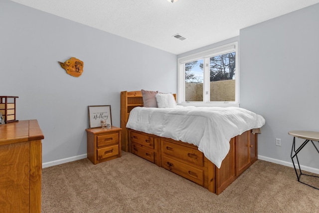 bedroom with light colored carpet, visible vents, and baseboards