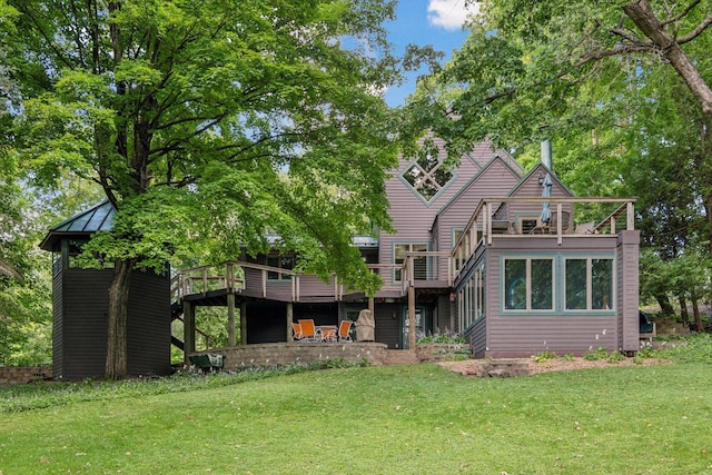 back of property featuring a yard and a wooden deck