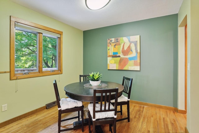 dining space with light hardwood / wood-style floors