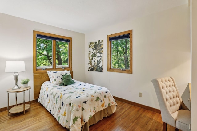 bedroom featuring multiple windows and hardwood / wood-style flooring