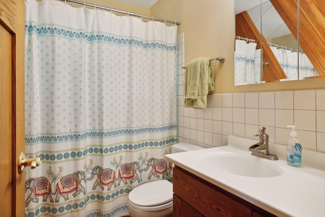 bathroom featuring tasteful backsplash, vanity, tile walls, toilet, and curtained shower