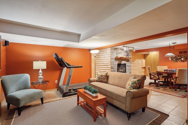 living room featuring light tile patterned flooring and a stone fireplace