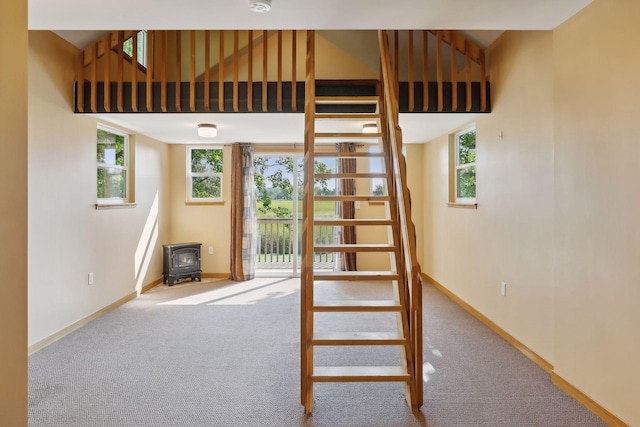 stairs with carpet flooring and a wood stove