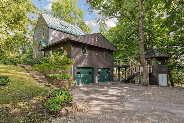 view of property exterior featuring a wooden deck and a garage