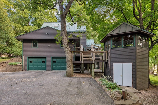 exterior space featuring a garage and a wooden deck