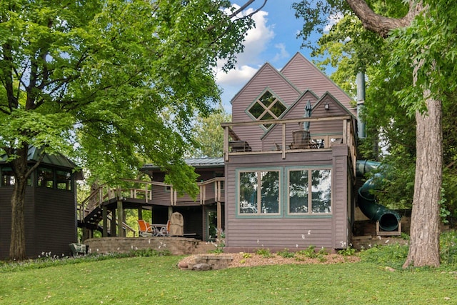 back of property featuring a lawn and a deck