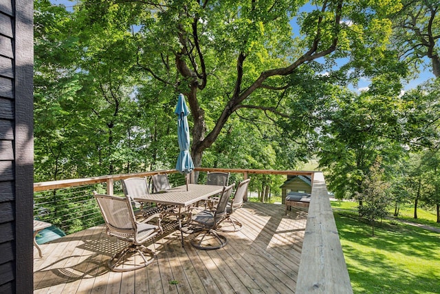 wooden terrace featuring a yard