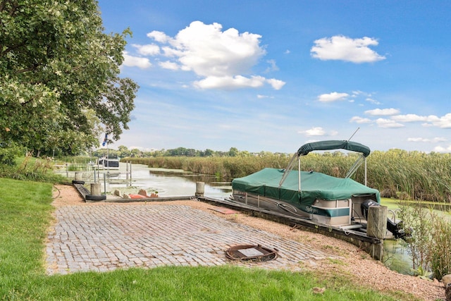 view of patio with a boat dock and a water view