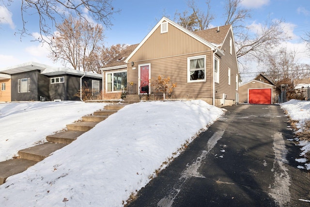 view of front of home with a garage and an outdoor structure