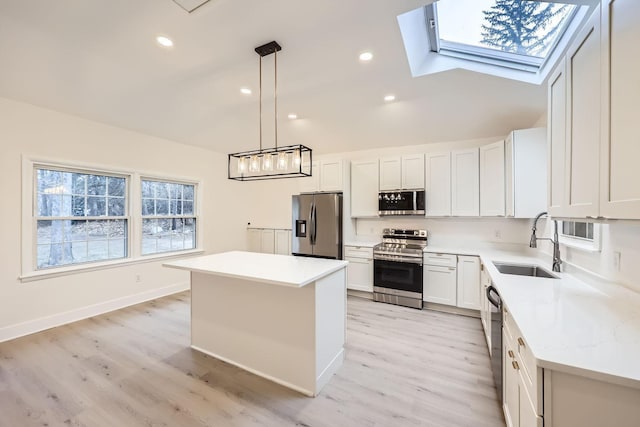 kitchen with white cabinetry, a center island, sink, hanging light fixtures, and stainless steel appliances